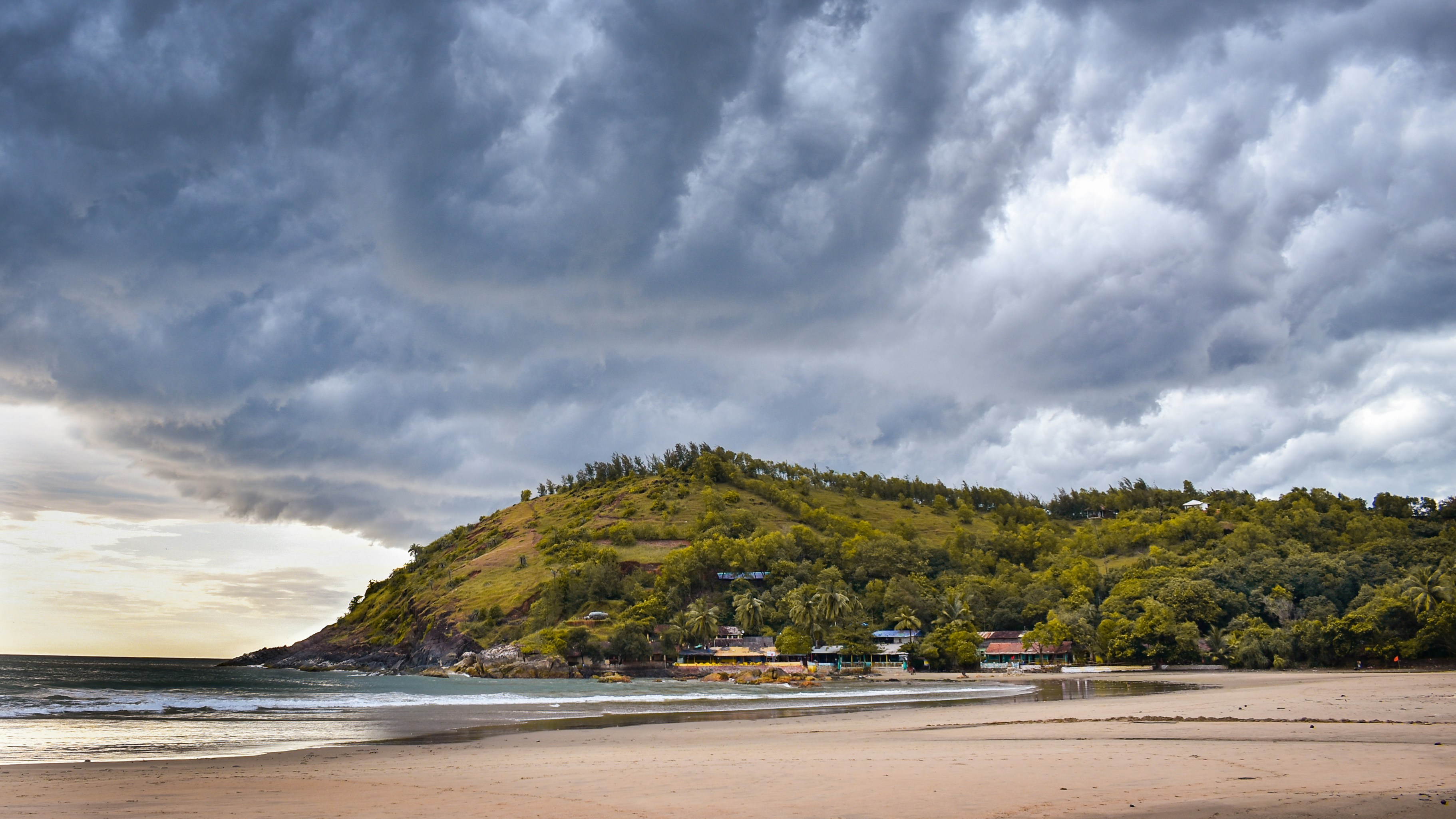 Green coastal landscape at Kudle Beach during monsoon